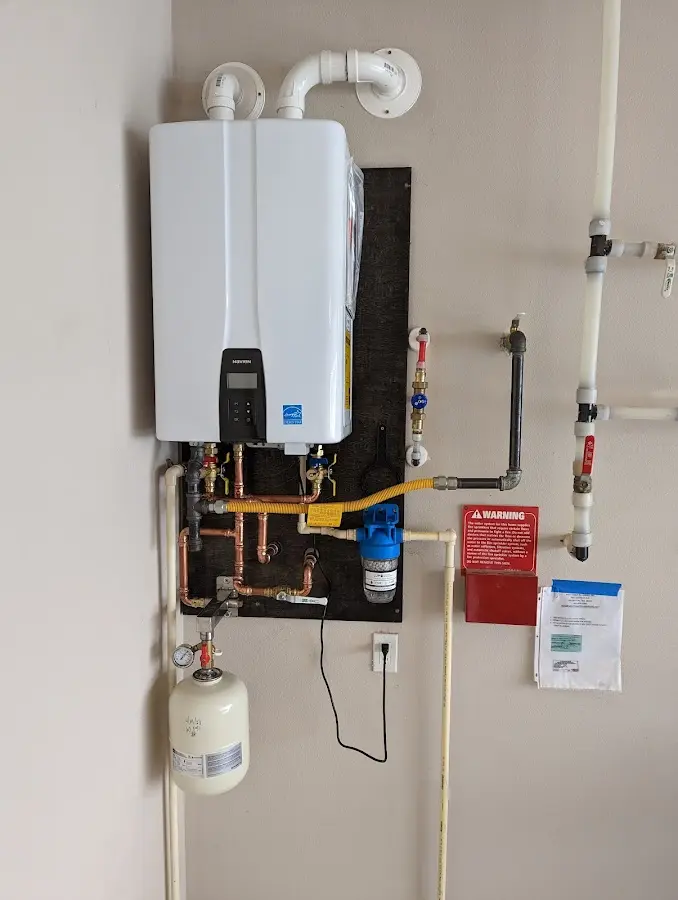 Professional plumber installing copper piping in a Noblesville home